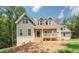 Charming two-story home with a welcoming front porch and well-manicured lawn in a wooded setting at 220 Nicklaus Cir, Social Circle, GA 30025