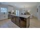 Modern kitchen featuring a center island with wood cabinets, seating, and stainless steel appliances at 220 Nicklaus Cir, Social Circle, GA 30025
