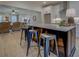 Open floor plan kitchen featuring a dark island with seating and stainless steel bar stools at 220 Nicklaus Cir, Social Circle, GA 30025