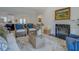 Comfortable living room with wicker chairs, stylish decor, and an inviting fireplace on a light colored wall at 220 Nicklaus Cir, Social Circle, GA 30025