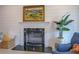 Elegant fireplace with a black marble hearth, framed by a classic white mantel and light colored wall at 220 Nicklaus Cir, Social Circle, GA 30025