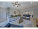 Bright, open living room featuring a ceiling fan, hardwood floors, and stylish wicker furniture at 220 Nicklaus Cir, Social Circle, GA 30025