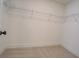 Walk-in closet features wall shelving and carpet flooring at 220 Nicklaus Cir, Social Circle, GA 30025