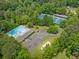 Aerial view showcases community pool, tennis courts, and lush surrounding landscape at 2920 Alberta Dr, Marietta, GA 30062