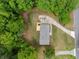 Aerial view of a home with a lush yard and long driveway nestled amongst green trees at 2920 Alberta Dr, Marietta, GA 30062