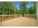 An outdoor wooden deck and railing surrounded by lush green trees at 2920 Alberta Dr, Marietta, GA 30062