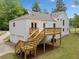 Spacious backyard featuring a wooden deck, stairs, and a two-car garage, set on a lush lawn at 2920 Alberta Dr, Marietta, GA 30062