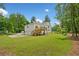 Expansive backyard featuring a wooden deck, two-car garage, and lush greenery, perfect for outdoor living at 2920 Alberta Dr, Marietta, GA 30062