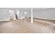 Large basement area with wood-look flooring and multiple white support columns offers flexible living at 2920 Alberta Dr, Marietta, GA 30062