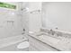 Elegant bathroom featuring marble-like tiles, granite countertop, and modern fixtures at 2920 Alberta Dr, Marietta, GA 30062