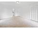 Bright bedroom with carpet and neutral paint with a door to the bathroom and a closet with louvered doors at 2920 Alberta Dr, Marietta, GA 30062