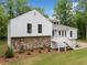 A beautiful home with a combination of stone and white siding, surrounded by mature trees at 2920 Alberta Dr, Marietta, GA 30062