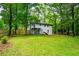 Wide shot of the backyard showcasing a white house with a deck and stair access at 5857 Earlwane Dr, Lithonia, GA 30058