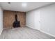 View of the basement featuring an antique coal stove and light wood flooring at 5857 Earlwane Dr, Lithonia, GA 30058