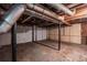 Spacious basement with unfinished concrete floors, exposed pipes, and a double door garage entry at 5857 Earlwane Dr, Lithonia, GA 30058