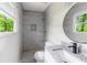 Stylish bathroom featuring tiled shower, modern vanity with dark hardware and sink at 5857 Earlwane Dr, Lithonia, GA 30058