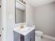 Bright bathroom features modern fixtures, vanity with sink, mirror, and toilet at 5857 Earlwane Dr, Lithonia, GA 30058