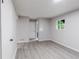 Bedroom with wood-look floors, neutral walls, and natural light at 5857 Earlwane Dr, Lithonia, GA 30058