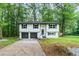 Charming two-story home with a well-maintained front yard and a two car garage at 5857 Earlwane Dr, Lithonia, GA 30058