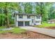 View of the exterior of the home, showing landscaping and two car garage at 5857 Earlwane Dr, Lithonia, GA 30058