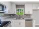 Tastefully updated kitchen featuring stainless steel appliances, granite countertops and modern backsplash at 5857 Earlwane Dr, Lithonia, GA 30058