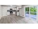 Modern kitchen featuring white cabinets and stainless steel appliances, and deck access at 5857 Earlwane Dr, Lithonia, GA 30058