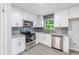 Kitchen featuring white cabinets, stainless steel appliances, and granite countertops at 5857 Earlwane Dr, Lithonia, GA 30058