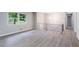 Open living area featuring sleek floors and a modern light fixture at 5857 Earlwane Dr, Lithonia, GA 30058