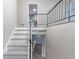 Bright staircase with white steps and black metal railing at 5857 Earlwane Dr, Lithonia, GA 30058