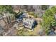 Stunning aerial shot of the home with mature landscaping, an in-ground pool, and a charming covered porch at 65 Deer Run Ln, Mcdonough, GA 30252