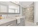 A modern bathroom featuring a double sink vanity, tiled floors, and a glass shower creates a luxurious space at 65 Deer Run Ln, Mcdonough, GA 30252