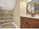 Cozy bathroom featuring decorative shelves, tile flooring, and a wooden framed mirror at 65 Deer Run Ln, Mcdonough, GA 30252