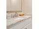 Bathroom vanity with a decorative mirror, a white sink, and natural stone countertop at 65 Deer Run Ln, Mcdonough, GA 30252