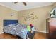 Bedroom with hardwood flooring, large window and dinosaur decals at 65 Deer Run Ln, Mcdonough, GA 30252