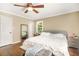 A cozy bedroom featuring a ceiling fan, hardwood floors, and a comfortable bed offers a relaxing retreat at 65 Deer Run Ln, Mcdonough, GA 30252