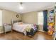 Bedroom with hardwood flooring, a large window, and comfortable furniture at 65 Deer Run Ln, Mcdonough, GA 30252