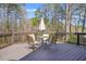 Spacious outdoor deck perfect for entertaining with a dining set, offering serene woodland views at 65 Deer Run Ln, Mcdonough, GA 30252