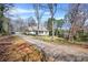 Long driveway leading to charming home with a welcoming front porch and manicured lawn at 65 Deer Run Ln, Mcdonough, GA 30252