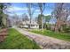 Long driveway leading to charming home with a welcoming front porch and manicured lawn at 65 Deer Run Ln, Mcdonough, GA 30252