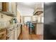 An open kitchen with granite countertops, an island with seating, and wood floors offers a welcoming and functional space at 65 Deer Run Ln, Mcdonough, GA 30252