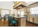 A kitchen island with granite counters, seating, and a unique vent hood enhances the kitchen's style and practicality at 65 Deer Run Ln, Mcdonough, GA 30252