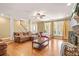Spacious living room with wood floors, fireplace, and lots of natural light at 65 Deer Run Ln, Mcdonough, GA 30252