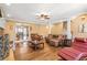 Open-concept living room featuring hardwood floors, fireplace, and natural light at 65 Deer Run Ln, Mcdonough, GA 30252