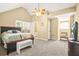Spacious main bedroom featuring a ceiling fan, neutral walls, carpet flooring, and natural light at 65 Deer Run Ln, Mcdonough, GA 30252