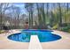 Refreshing in-ground pool with diving board and secure fencing, ideal for summer fun and relaxation at 65 Deer Run Ln, Mcdonough, GA 30252