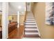 Staircase features wood and white design with a view of the living room at 65 Deer Run Ln, Mcdonough, GA 30252