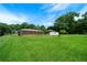 A well-maintained backyard featuring a shed and mature trees at 87 Virgil Sw St, Mableton, GA 30126