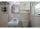 Bathroom with tiled walls, sink, toilet, and shower with rack at 87 Virgil Sw St, Mableton, GA 30126