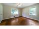 Bedroom with ceiling fan and gleaming hardwood floors and multiple windows at 87 Virgil Sw St, Mableton, GA 30126