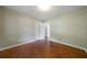 This bedroom features hardwood floors, neutral paint, a closet, a window, and white trim at 87 Virgil Sw St, Mableton, GA 30126